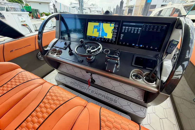 Slide: The Image of Helm of 2025 Midnight Express 43 Solstice with advanced navigation displays and luxurious seating. - 1