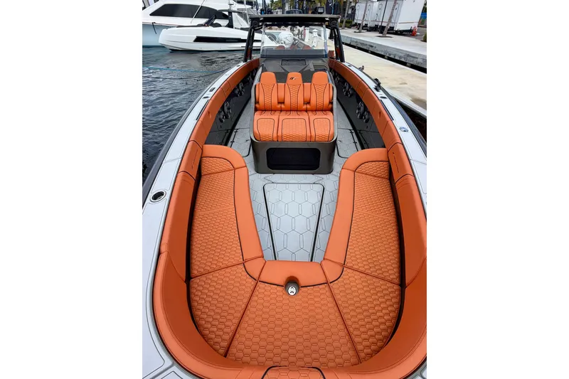 Slide: The Image of 2025 Midnight Express 43 Solstice boat with luxurious orange seating and sleek design. - 10