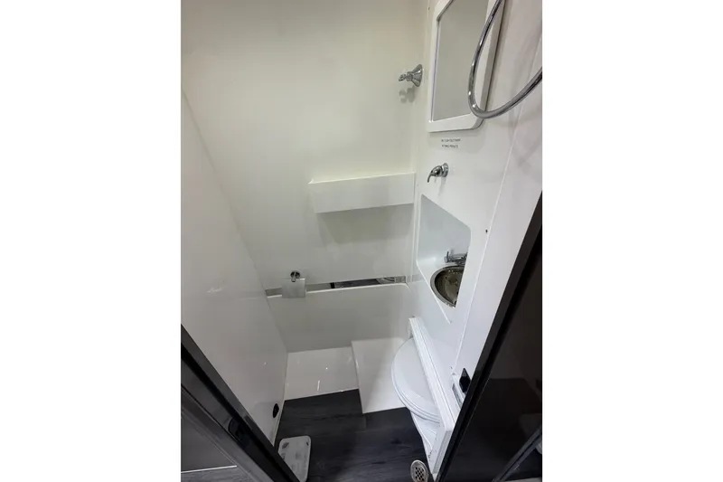 Slide: The Image of Compact bathroom in 2025 Midnight Express 43 Solstice boat, featuring modern fixtures and sleek design. - 15