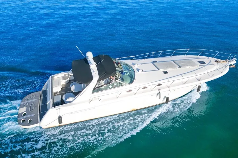 The Image of 1997 Sea Ray 500 Sundancer yacht cruising on clear blue water. - 1