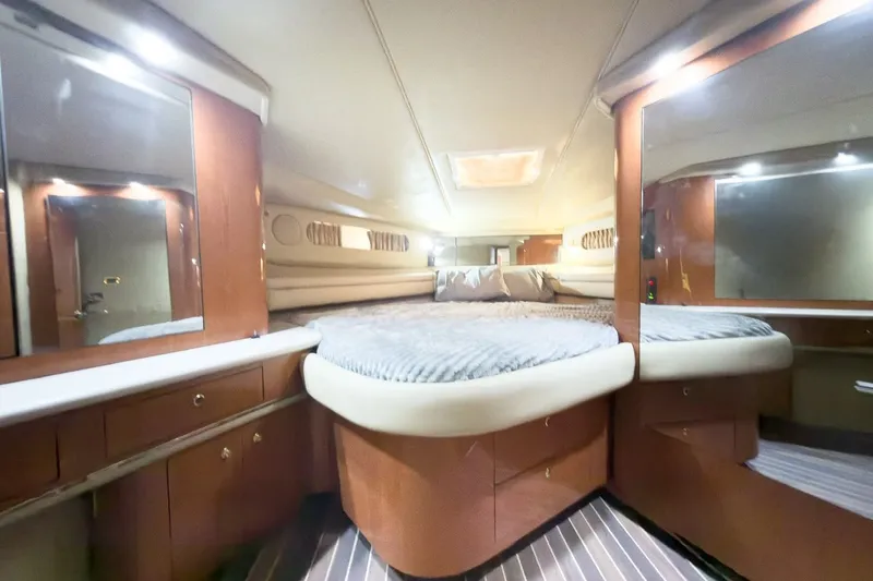 Slide: The Image of Luxurious cabin interior of 1997 Sea Ray 500 Sundancer yacht with cozy bed and wooden cabinetry. - 15