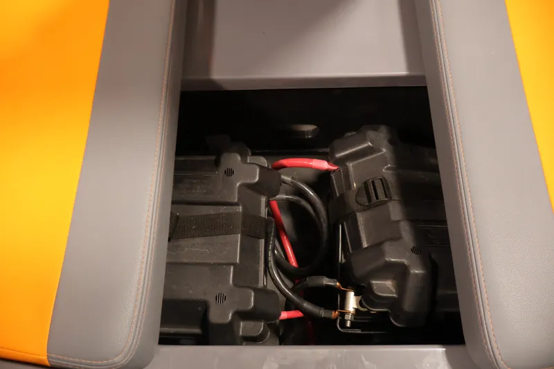 Slide: The Image of Battery compartment of 2025 Axis T250 boat with visible wiring and secure casing. - 15