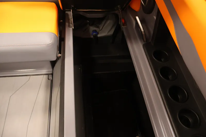 Slide: The Image of Interior of 2025 Axis T250 boat with orange and gray seating, storage, and cup holders. - 34