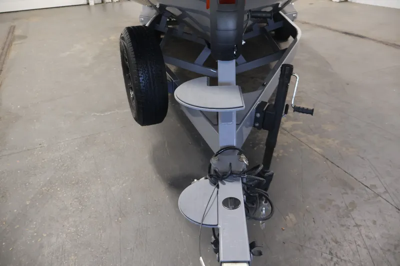 Slide: The Image of Trailer hitch of 2025 Axis T250 boat, featuring sturdy construction and spare tire. - 51