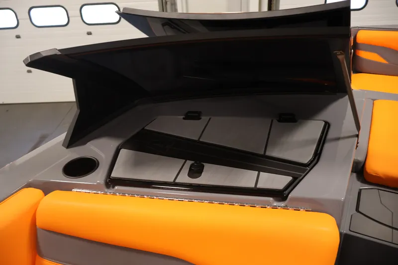 Slide: The Image of 2025 Axis T250 boat interior with orange seating and storage compartment. - 27