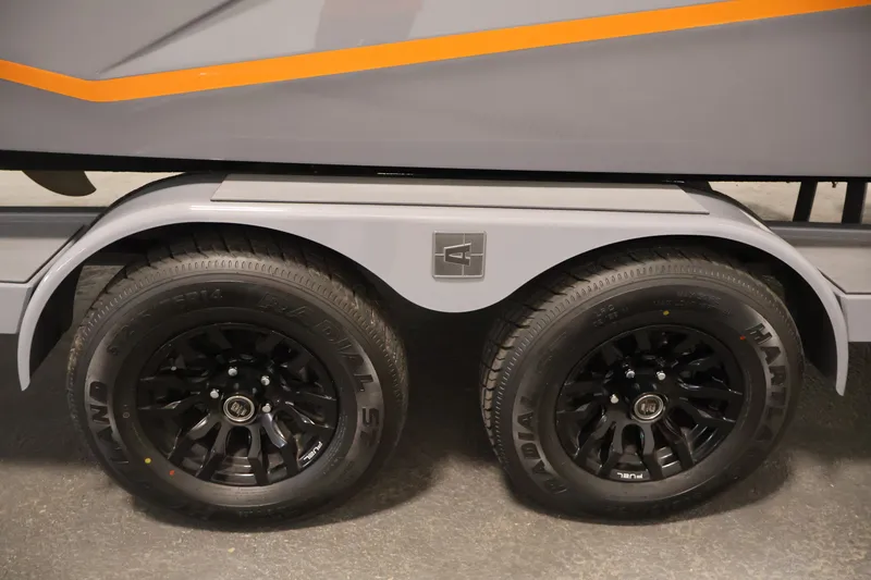 Slide: The Image of 2025 Axis T250 trailer with dual black wheels and orange accent stripe. - 54