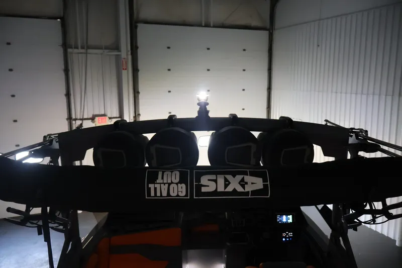 Slide: The Image of 2025 Axis T250 boat interior with speakers and 'Goal Out' branding in a garage setting. - 62
