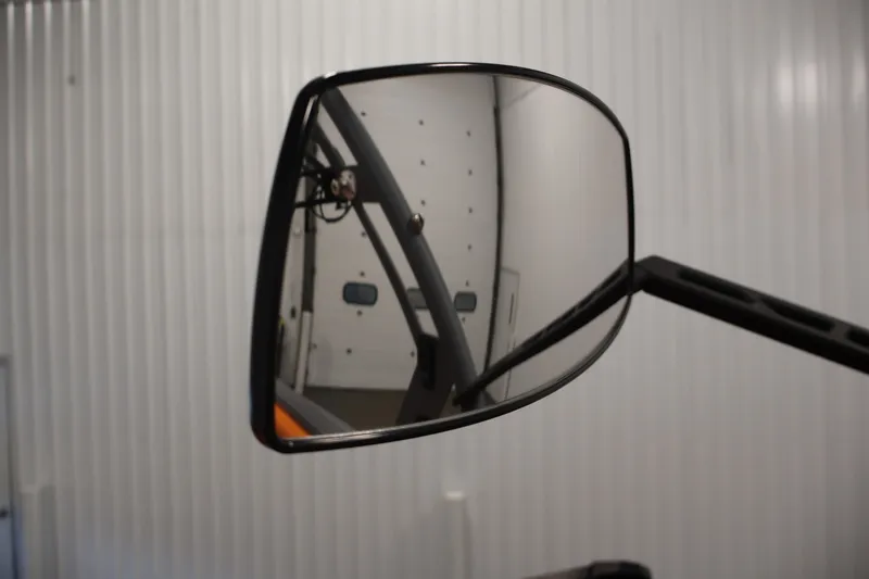 Slide: The Image of Side mirror of 2025 Axis T250 vehicle reflecting a garage interior. - 29
