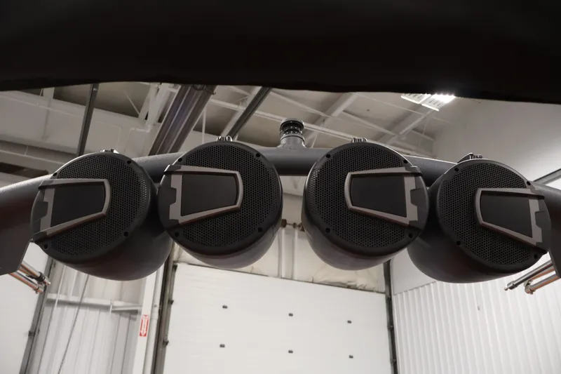 Slide: The Image of Four black speakers mounted on a bar inside a 2025 Axis T250 boat. - 44