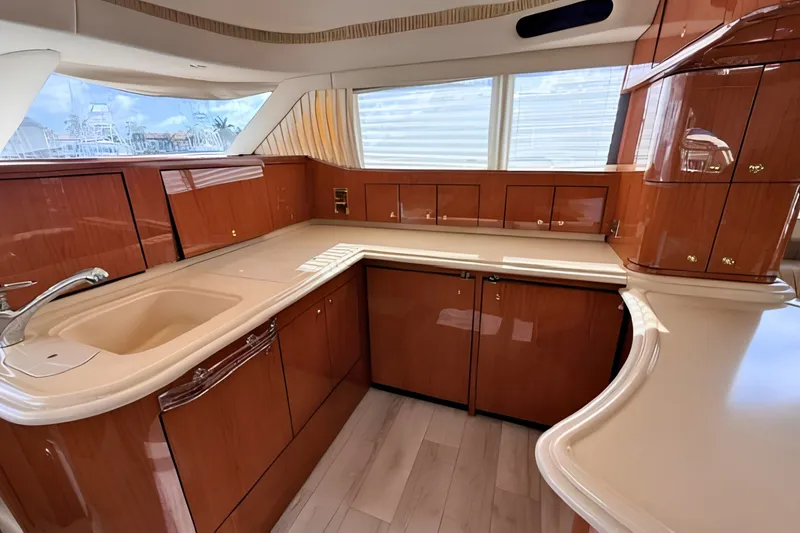 Slide: The Image of Luxurious kitchen interior of 2000 Sea Ray 560 Sedan Bridge yacht with wood cabinetry. - 14
