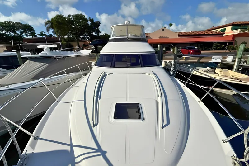Slide: The Image of 2000 Sea Ray 560 Sedan Bridge yacht docked at marina under blue sky. - 11