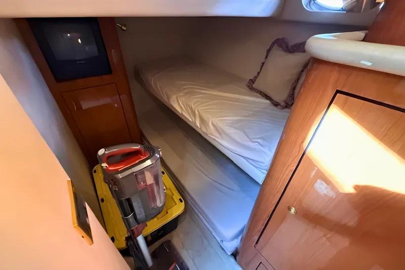 Slide: The Image of Compact cabin interior of 2000 Sea Ray 560 Sedan Bridge with bunk bed and storage. - 18