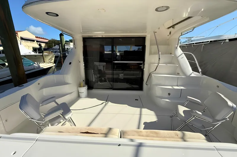 Slide: The Image of Spacious deck of 2000 Sea Ray 560 Sedan Bridge with seating and stairs. - 4