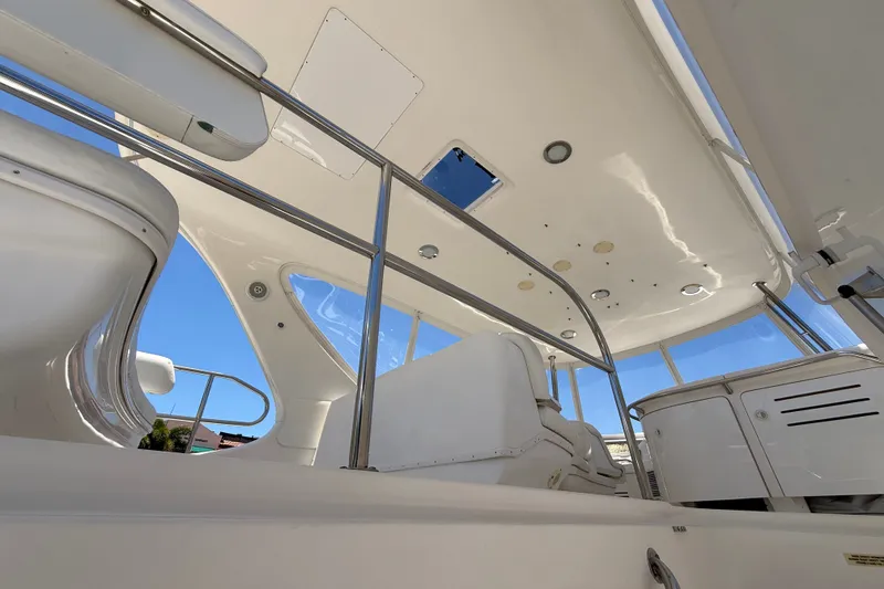 Slide: The Image of Interior view of 2000 Sea Ray 560 Sedan Bridge yacht, featuring sleek white seating and modern design. - 7