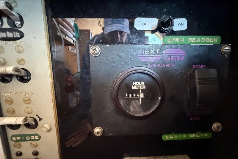 Slide: The Image of Control panel of a 1971 Bertram 35 Sport Fisherman with hour meter and switches. - 34