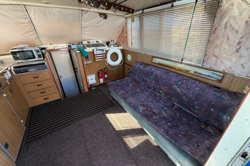 Slide: The Image of Interior of a 1971 Bertram 35 Sport Fisherman with sofa, kitchenette, and nautical decor. - 16