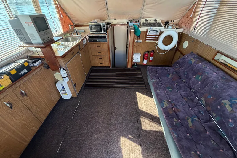 Slide: The Image of Interior of a 1971 Bertram 35 Sport Fisherman with kitchenette and seating area. - 15