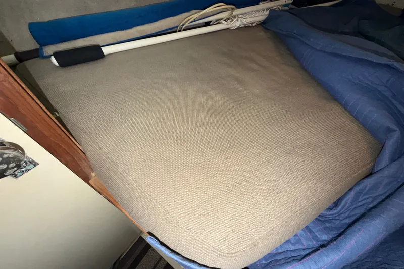 Slide: The Image of Cushioned interior of 1971 Bertram 35 Sport Fisherman boat with blue bedding. - 28