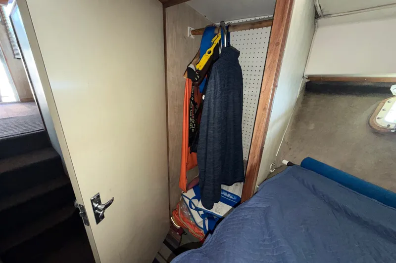 Slide: The Image of Interior of 1971 Bertram 35 Sport Fisherman with hanging clothes and bed. - 29