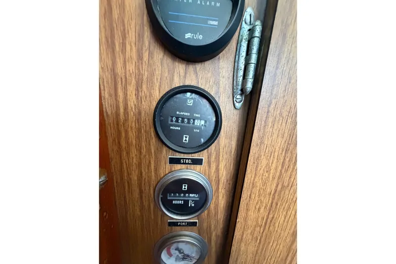 Slide: The Image of 1971 Bertram 35 Sport Fisherman dashboard with gauges and wooden paneling. - 35