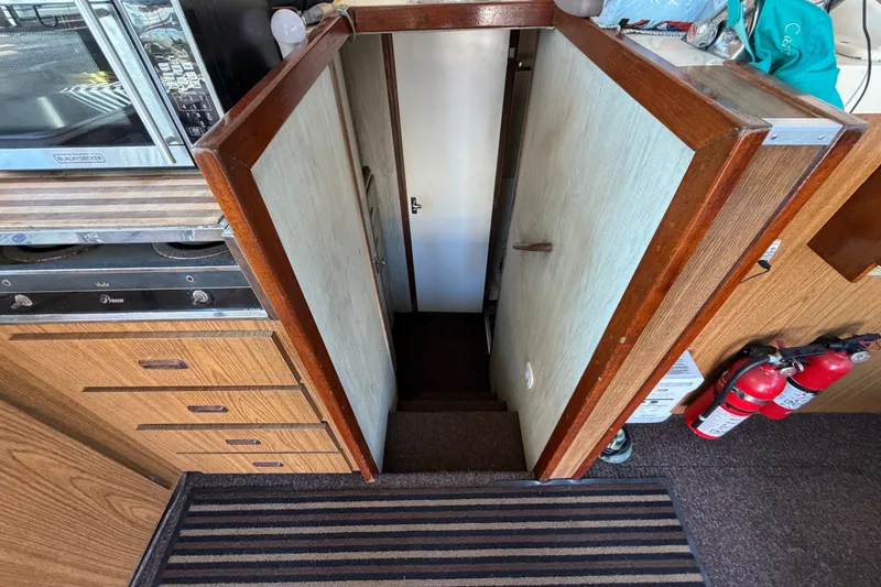 Slide: The Image of Interior view of 1971 Bertram 35 Sport Fisherman, showing stairs and wooden cabinetry. - 23