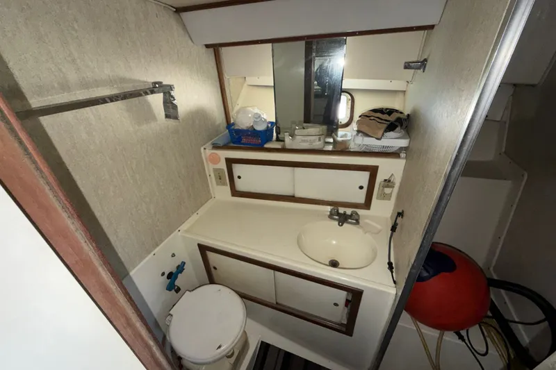 Slide: The Image of 1971 Bertram 35 Sport Fisherman bathroom with sink, mirror, and toilet. - 24
