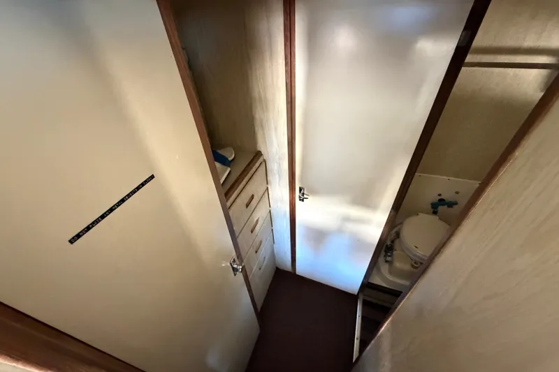 Slide: The Image of Interior of 1971 Bertram 35 Sport Fisherman, featuring compact bathroom and storage area. - 25