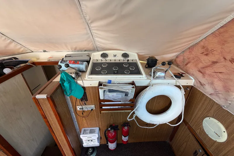 Slide: The Image of 1971 Bertram 35 Sport Fisherman helm with controls, gauges, and safety equipment. - 20