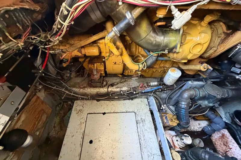 Slide: The Image of Engine room of a 1971 Bertram 35 Sport Fisherman boat, showing mechanical components and wiring. - 43