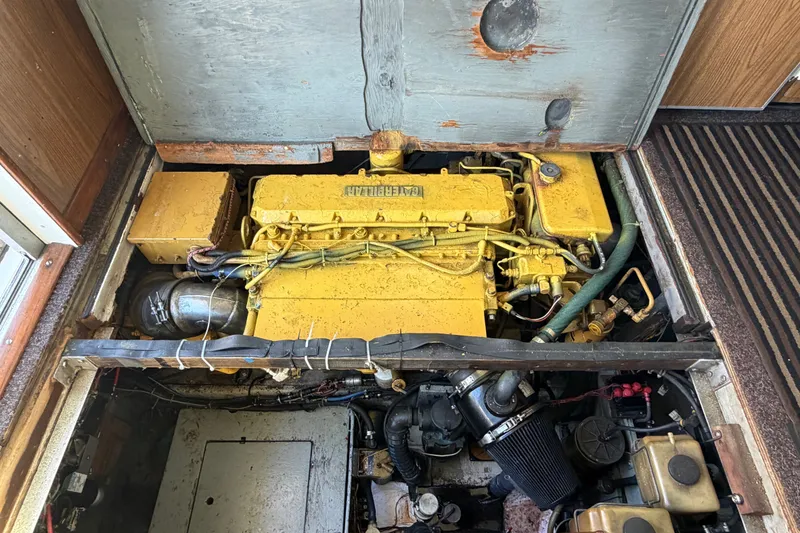 Slide: The Image of Engine compartment of a 1971 Bertram 35 Sport Fisherman boat, featuring a yellow engine. - 39