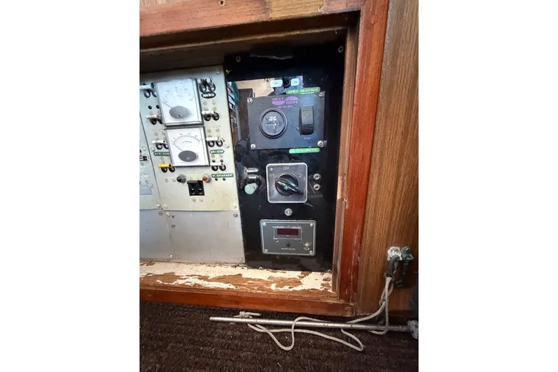 Slide: The Image of Electrical panel of a 1971 Bertram 35 Sport Fisherman boat, featuring gauges and switches. - 32