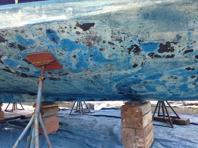 Slide: The Image of The hull of a 1988 Ocean Alexander 546 Cockpit Motoryacht is propped up for maintenance. - 27