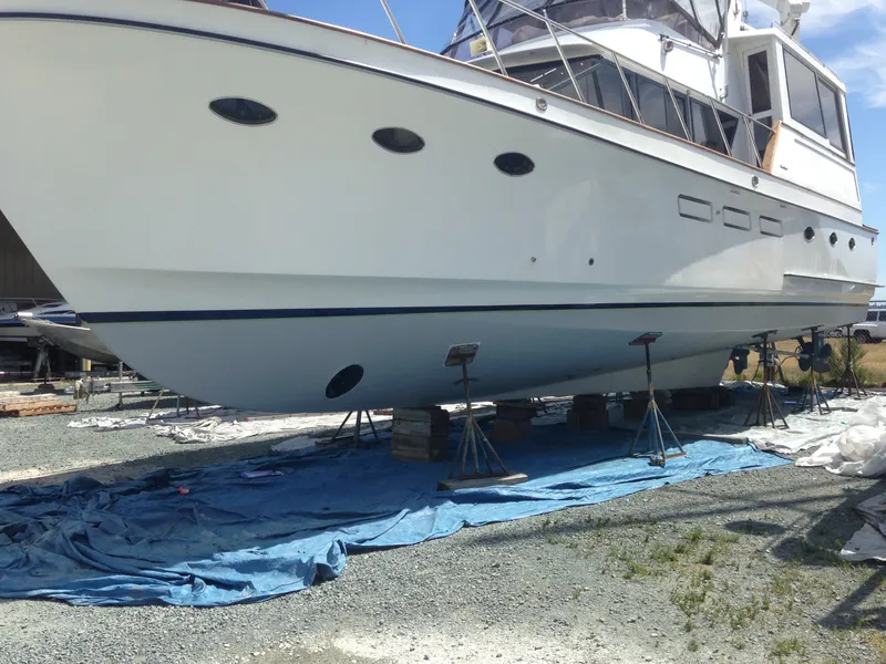 Slide: The Image of An Ocean Alexander 546 Cockpit Motoryacht from 1988 is on a dry dock, supported by stands. - 34