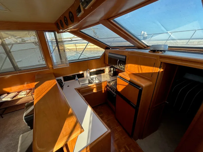 Slide: The Image of Interior view of a 1988 Ocean Alexander 546 Cockpit Motoryacht with kitchen and dining area. - 15
