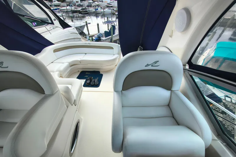 Slide: The Image of 2006 Sea Ray 340 Sundancer interior with plush seating and marina view. - 10
