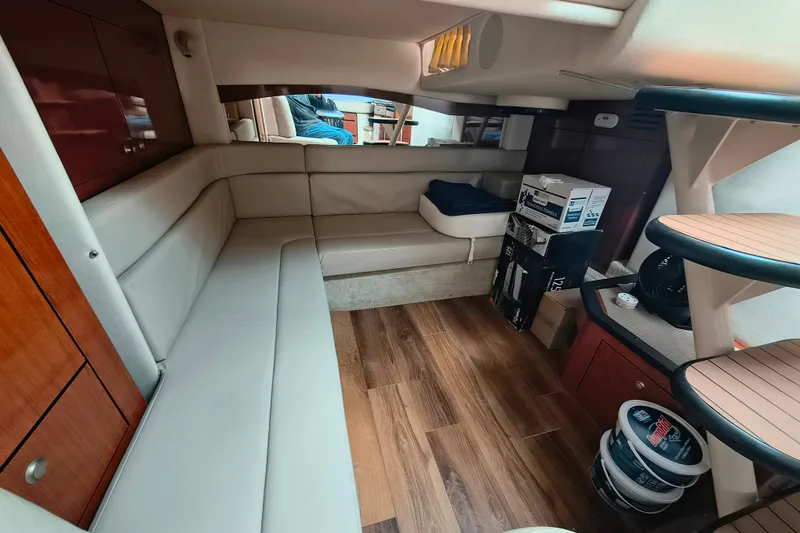 Slide: The Image of Interior of 2006 Sea Ray 340 Sundancer yacht with beige seating and wooden flooring. - 23