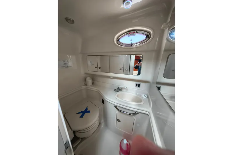 Slide: The Image of 2006 Sea Ray 340 Sundancer bathroom with sink, toilet, and mirror. - 24