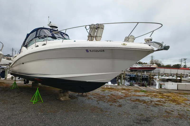 Slide: The Image of 2006 Sea Ray 340 Sundancer boat on stands in a marina setting. - 1
