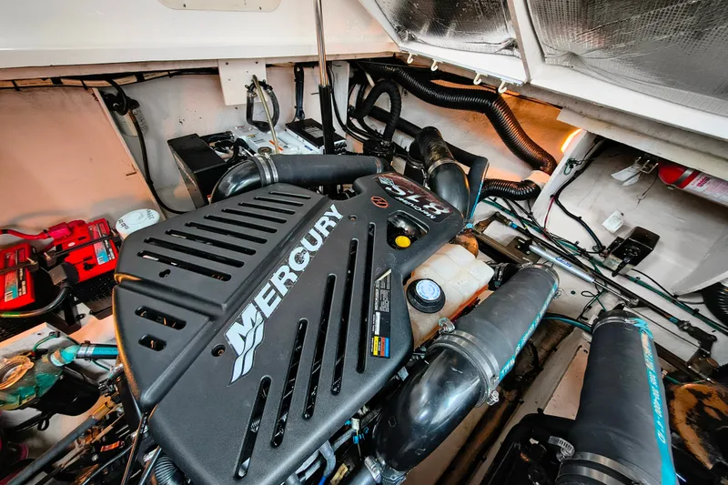 Slide: The Image of Engine compartment of a 2006 Sea Ray 340 Sundancer with Mercury engine components. - 26