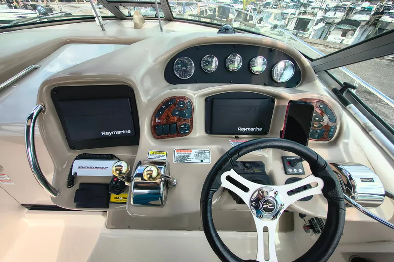 Slide: The Image of Cockpit of 2006 Sea Ray 340 Sundancer with Raymarine displays and steering wheel. - 14