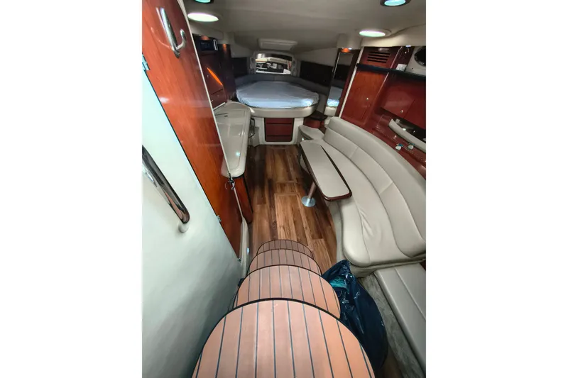 Slide: The Image of Interior of 2006 Sea Ray 340 Sundancer with wood flooring and beige seating. - 16