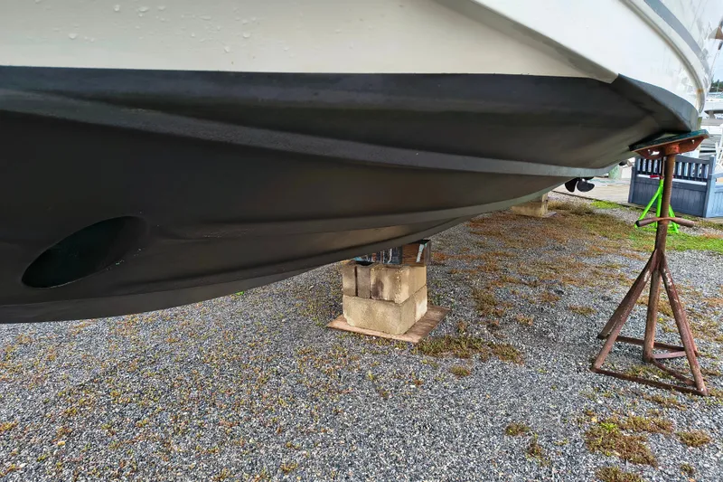Slide: The Image of 2006 Sea Ray 340 Sundancer boat hull on stands, displayed outdoors on gravel. - 4