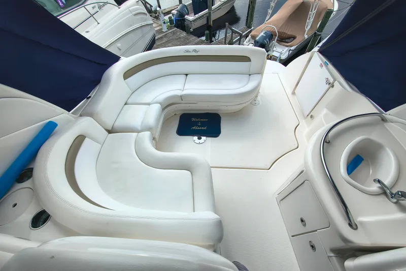 Slide: The Image of Luxurious 2006 Sea Ray 340 Sundancer boat interior with white seating and compact sink area. - 6