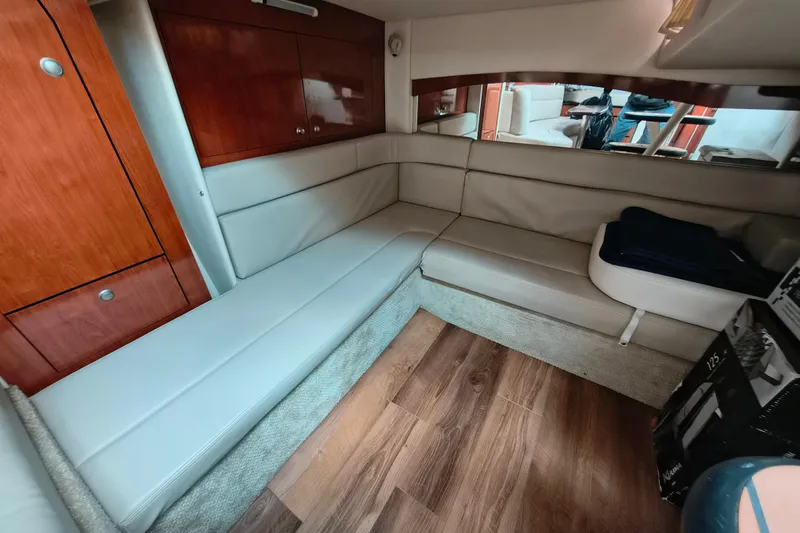 Slide: The Image of Interior of 2006 Sea Ray 340 Sundancer with beige seating and wooden cabinetry. - 22