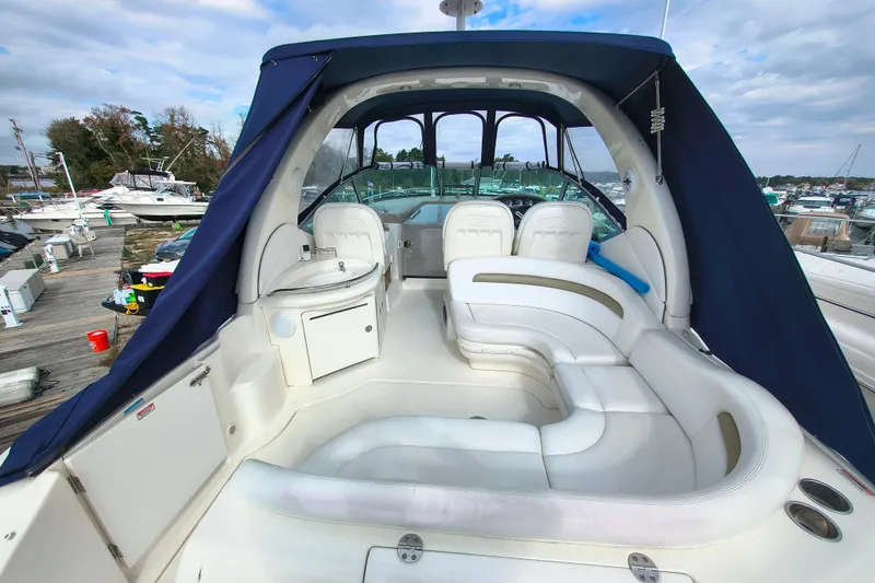 Slide: The Image of 2006 Sea Ray 340 Sundancer boat interior with white seating and blue canopy. - 5