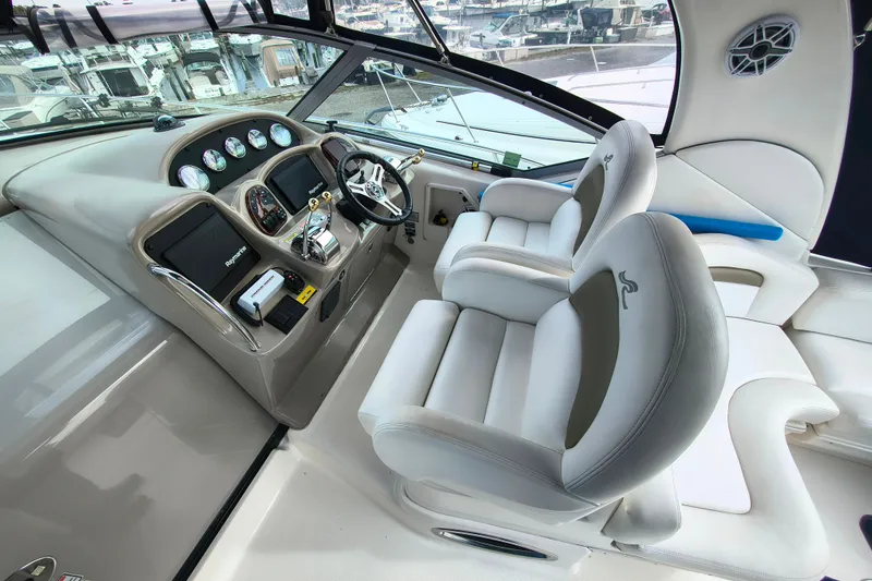 Slide: The Image of Cockpit of 2006 Sea Ray 340 Sundancer with dual helm seats and modern controls. - 13