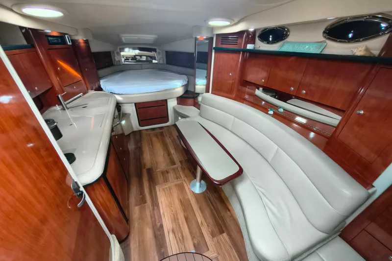Slide: The Image of Luxurious 2006 Sea Ray 340 Sundancer cabin with wood finish and cozy seating area. - 17