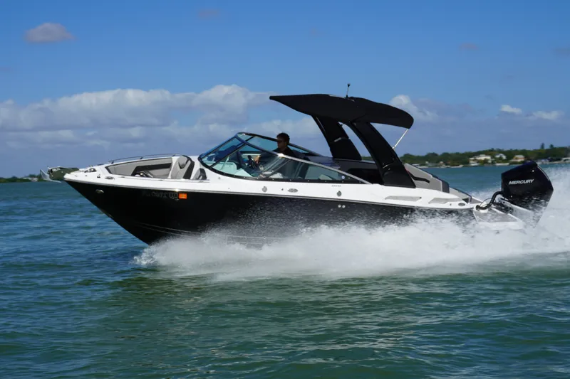 Slide: The Image of 2026 Monterey 255SS Super Sport boat cruising on open water under clear skies. - 35