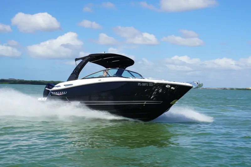 Slide: The Image of 2026 Monterey 255SS Super Sport boat speeding on open water under blue sky. - 38
