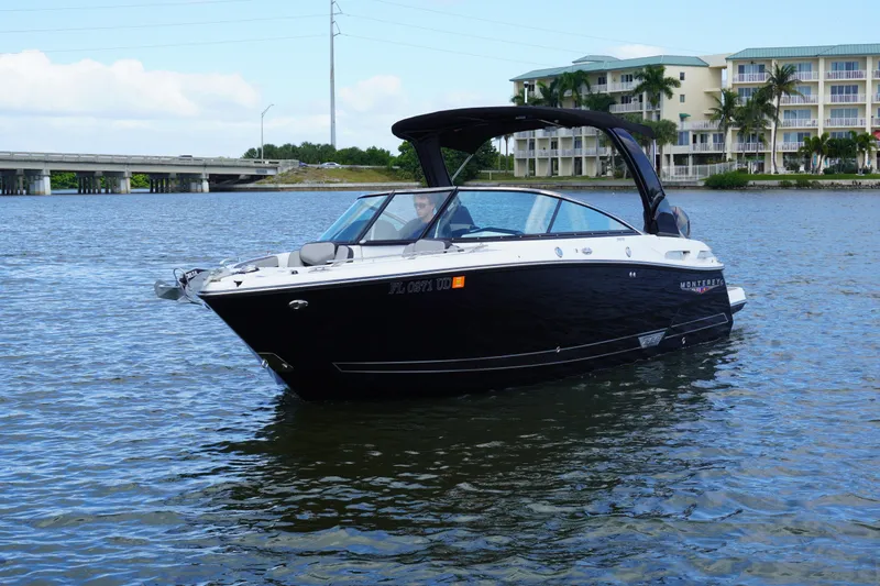 Slide: The Image of 2026 Monterey 255SS Super Sport boat on water near bridge and buildings. - 3